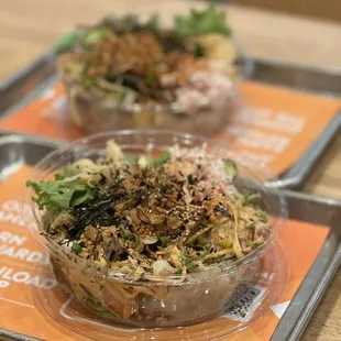 two bowls of food on a tray
