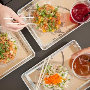 four bowls of food with chopsticks