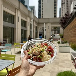 a person holding a bowl of food