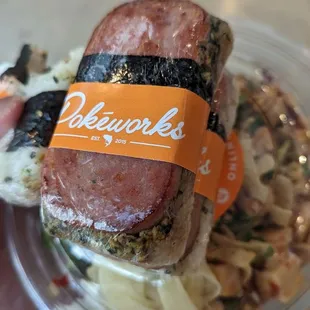 a hand holding a piece of food