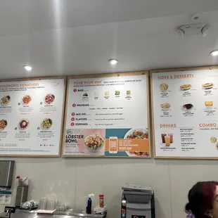 a woman sitting in front of a menu