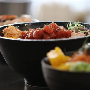 three bowls of food on a table