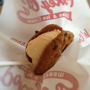 Chocolate chip cookies with vanilla ice cream in the middle.