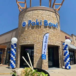 Poki bowl with mixed greens, salmon, tuna, shrimp, avocado, crab, green onions, both sauces and both shakers!