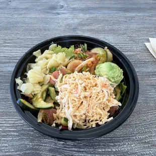 Regular size with 2 helpings of tuna and 1 helping of octopus over spring mix--very generous portions!