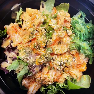 Specially marinated fresh salmon and shrimp poke bowl with vegetables. Topped with sesame seeds, chopped green onions, and spicy mayonnaise.