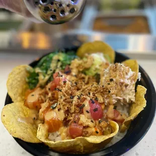 Delicious poke nachos with salmon and tuna, topped with crab meat, seaweed salad, house made spicy mayo and seaweed mix sprinkled on top.