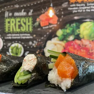 hree sushi rolls with salmon and cucumber