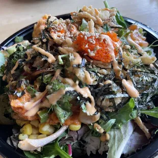 a black plate with a salad on it