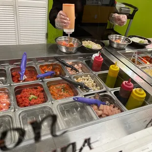 a woman preparing food at a buffet