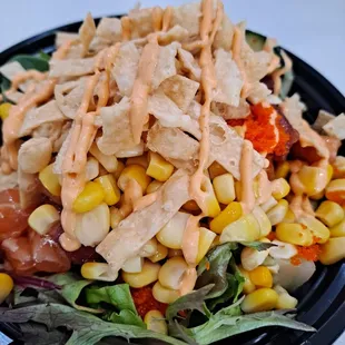 a black plate with a salad on it