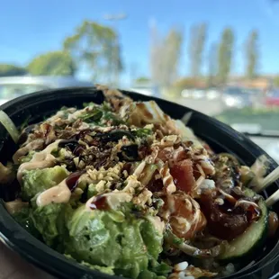 a hand holding a bowl of food