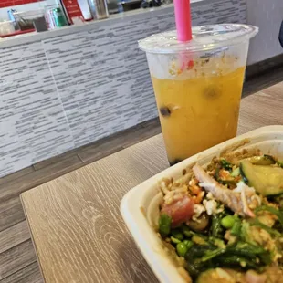 Poki bowl and mango green tea with boba.