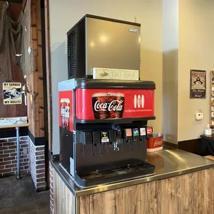 a coca cola machine on a counter