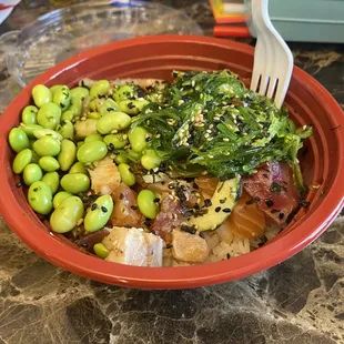 Poke bowl: albacore, salmon, tuna, sushi rice, edamame, onions, cucumber and seaweed salad topped with house poke sauce