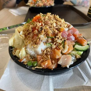 Mountain of poke in this medium bowl. Fresh and delicious. You can skip on the wonton chips.