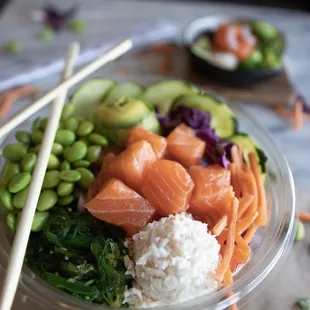 a bowl of food with chopsticks