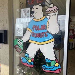 a polar bear holding a donut