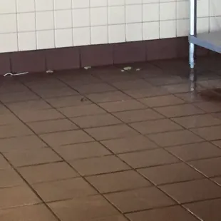 Food and trash on the floor at the counter