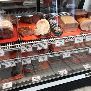 a variety of meats in a display case