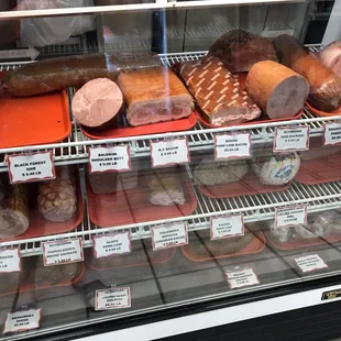 a variety of meats in a display case