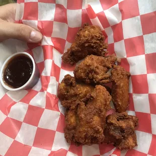 a basket of fried chicken and dipping sauce