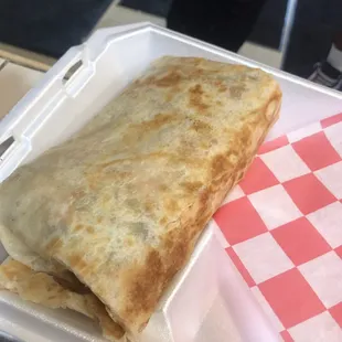 a burrito in a styrofoam container