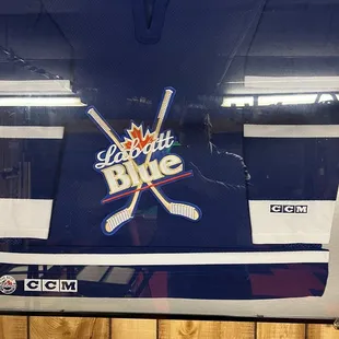 a hockey jersey hanging on a wall