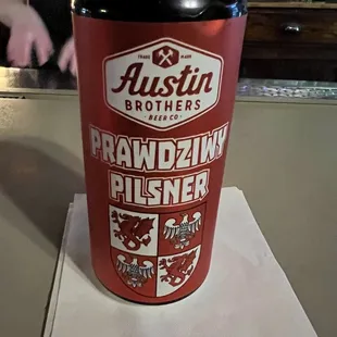 a can of beer on a napkin