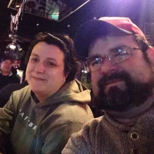 two men sitting at a bar