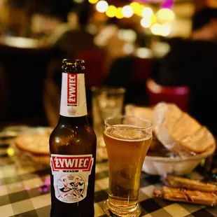 a bottle of beer and a glass of beer