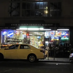 a yellow car parked in front of the store