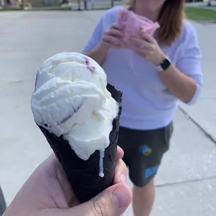 Blueberry Cheesecake in black vanilla cone. Cotton candy burrito in back.