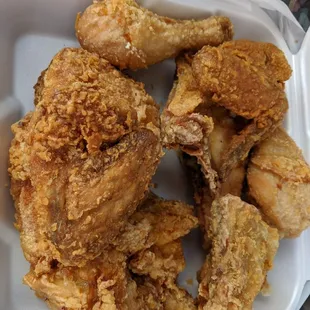 a close up of a chicken in a styrofoam container