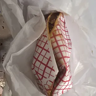 a sandwich wrapped in paper