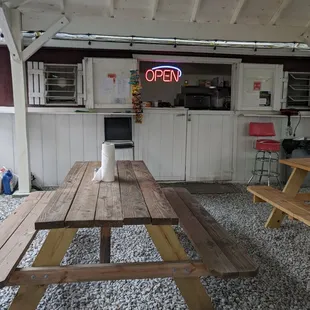 a picnic table with a neon sign