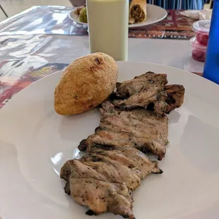 Chicken thigh with a chicken stuffed potato.