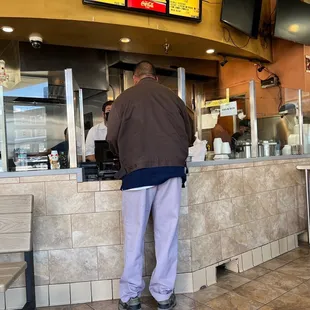 A customer and the grumpy owner who lacks manners and customer service.