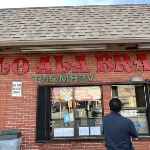 a man standing in front of a restaurant