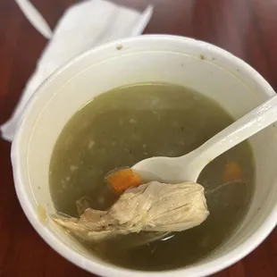 One piece of chicken shred in a bowl of soup.