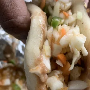 a person holding a hot dog