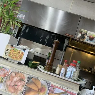 a restaurant counter with a variety of food items