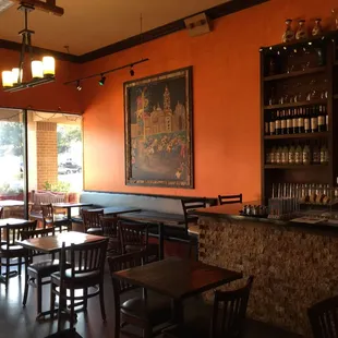 a dining area with tables and chairs