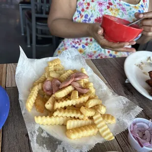 Crinkle cut french fries with hotdogs