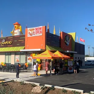 people standing outside of a restaurant