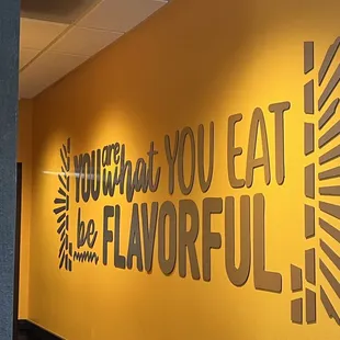 a yellow wall with a sign that says, you can't eat the flavorful
