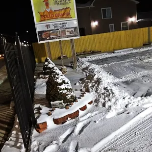 a snow covered parking lot at night