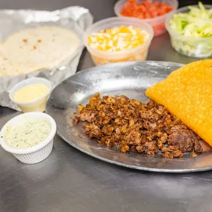 a plate of tacos and a bowl of salsa