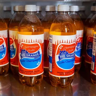 six bottles of orange soda