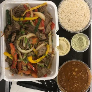 Lomo saltado (beef) with a side of pinto bean soup.
